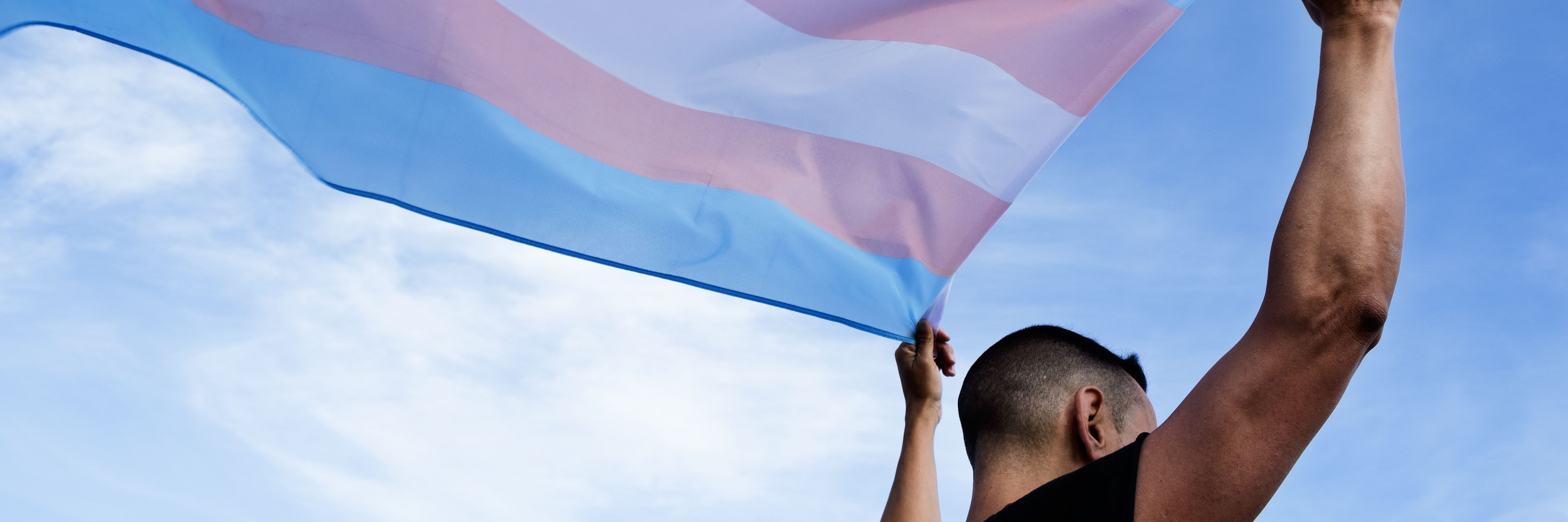 waiving transgender flag